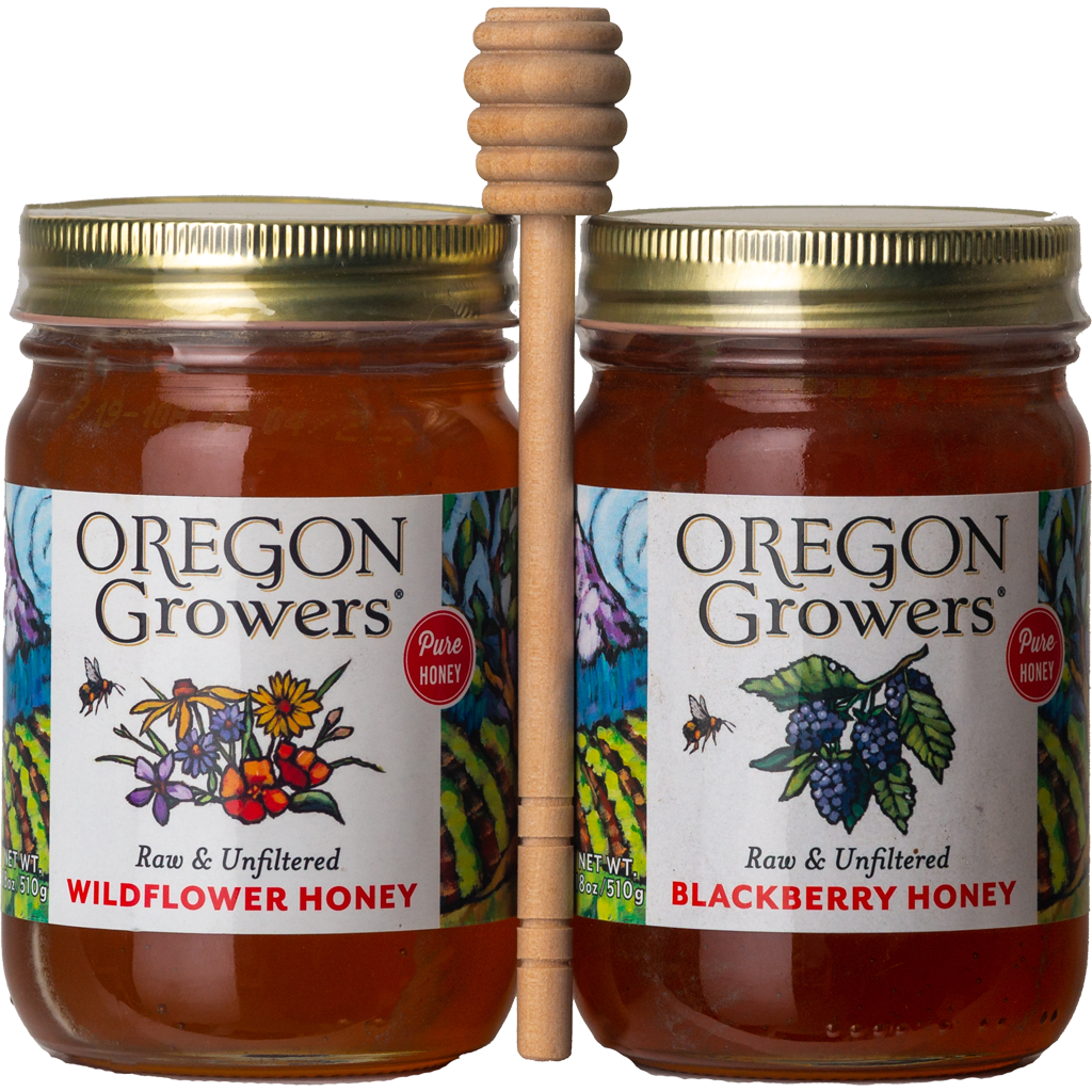 A close-up of a wooden honey dipper between our Wildflower and Blackberry Honey jars.