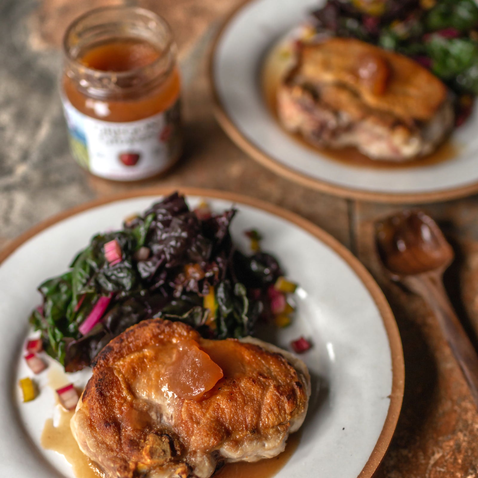 Table setting for a meal with plates of prepared food using our Apple Butter.