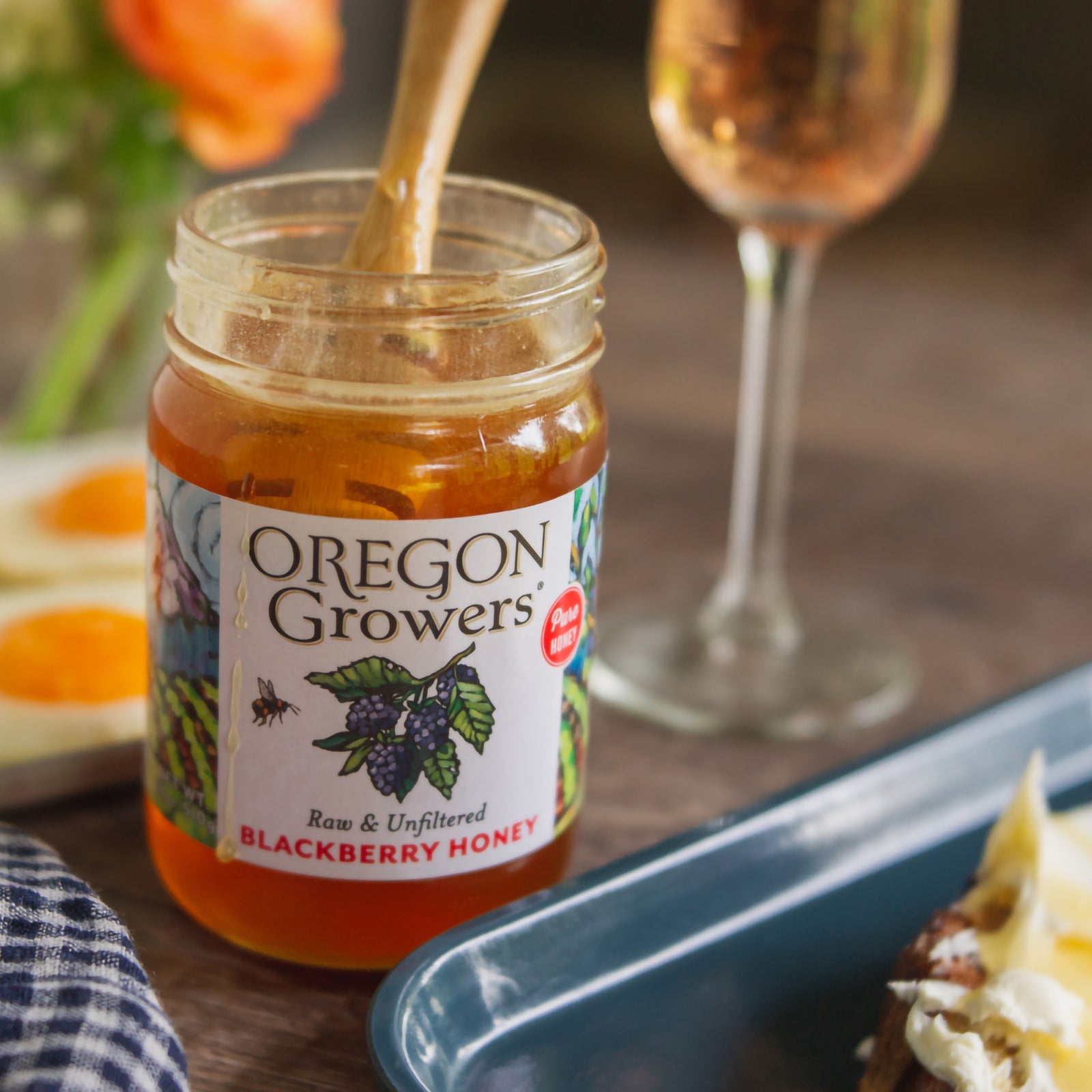 Close-up of our 18 oz Wildflower Honey jar on a breakfast table.