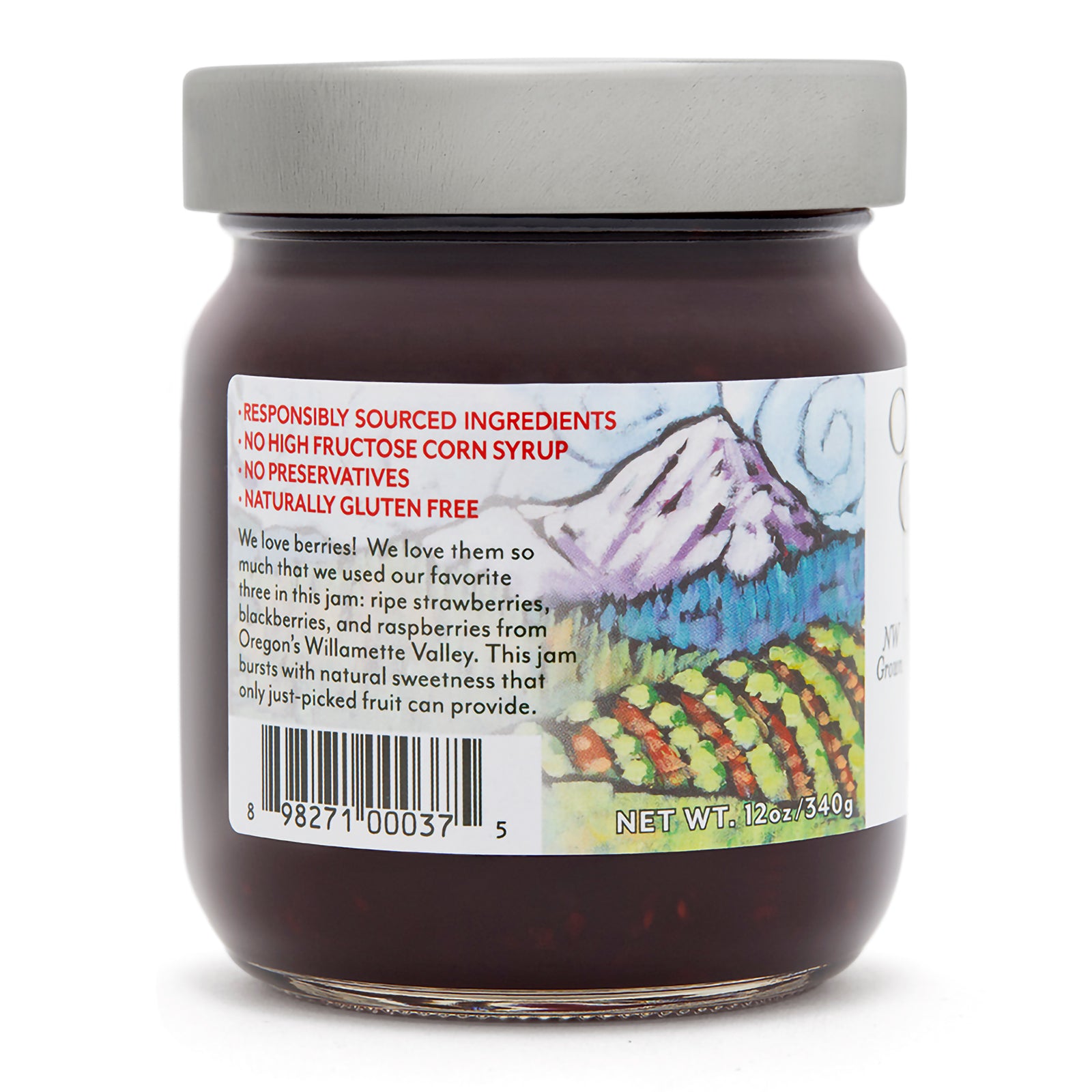 Close-up view (left side) of our  Oregon Growers Triple Berry Jam in the 12 oz. jar with label showing responsible sourcing information.