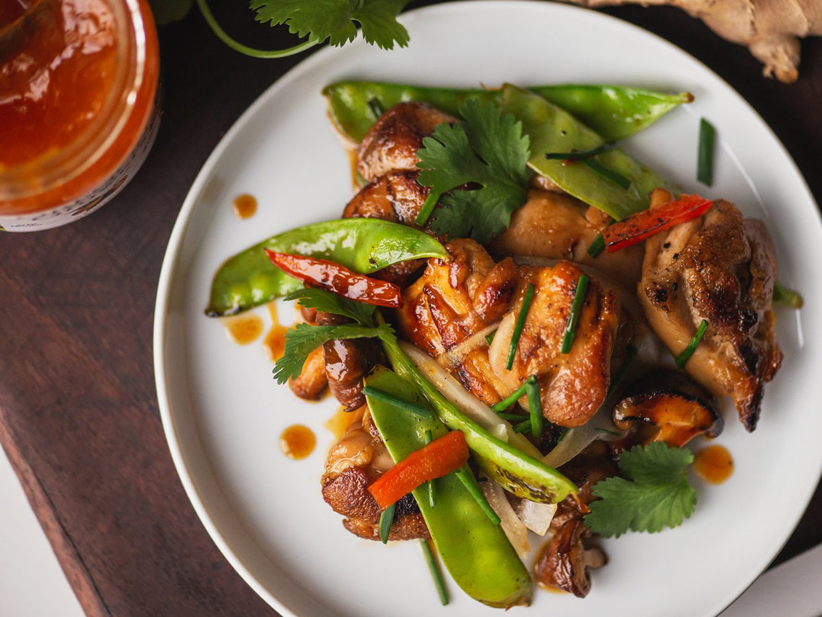 A plateful of chicken stir fry, prepared with a recipe using Oregon Growers Apricot Jam, rice, and vegetables.