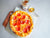 Top View of a Pizza on a Table Dripping with The DIY Hot Honey Recipe by Oregon Growers.