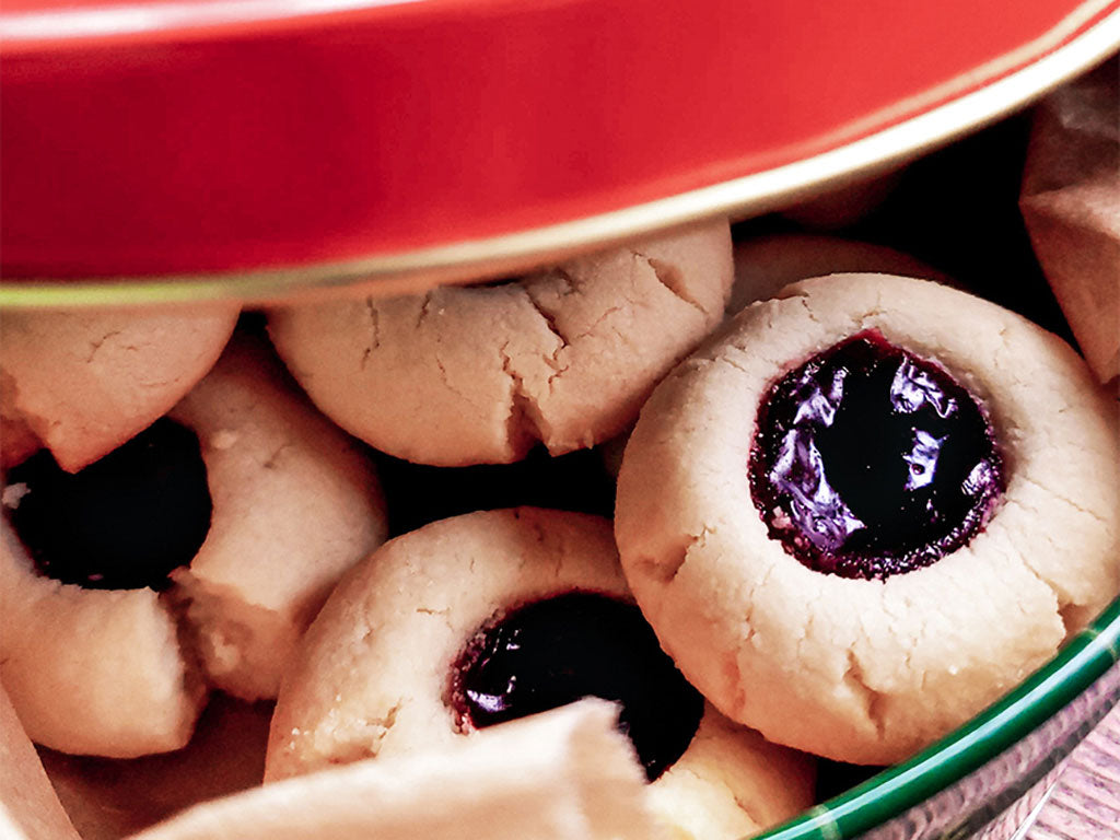 A bowl of Almond Thumbprint Cookies that were prepared using Oregon Growers Fruit Spread, flour, butter and sugar.