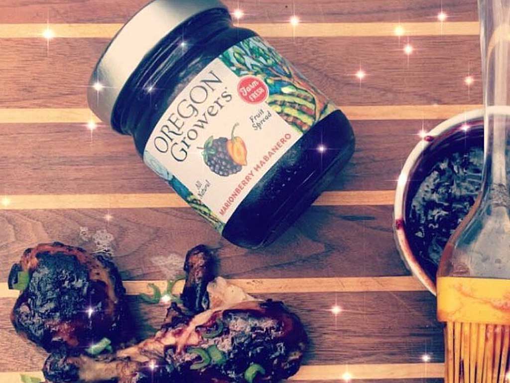 Chicken drumsticks glazed with Barbeque Sauce made from Oregon Growers Marionberry Habanero Jam. Garnished with green onions.