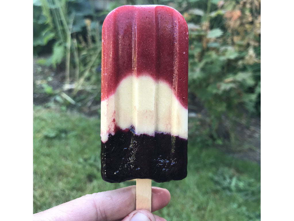 The Patriotic Summer Popsicle is red, white, and blue. Prepared with strawberries, Tahini, and Oregon Growers Huckleberry Jam.
