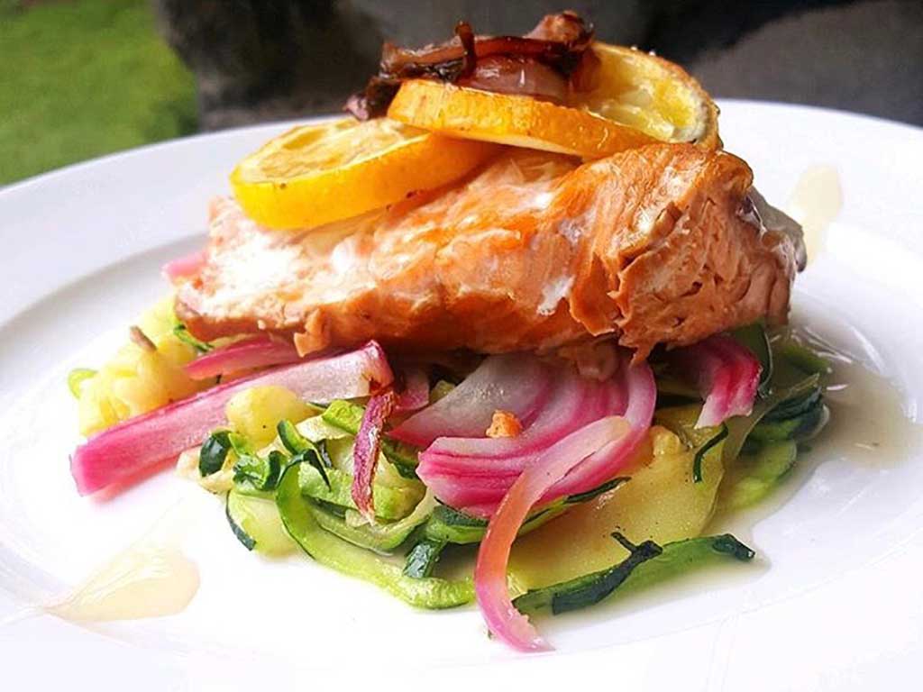Wild salmon served with zucchini and onions, topped with lemon slices and Oregon Growers Wildflower Honey glaze.