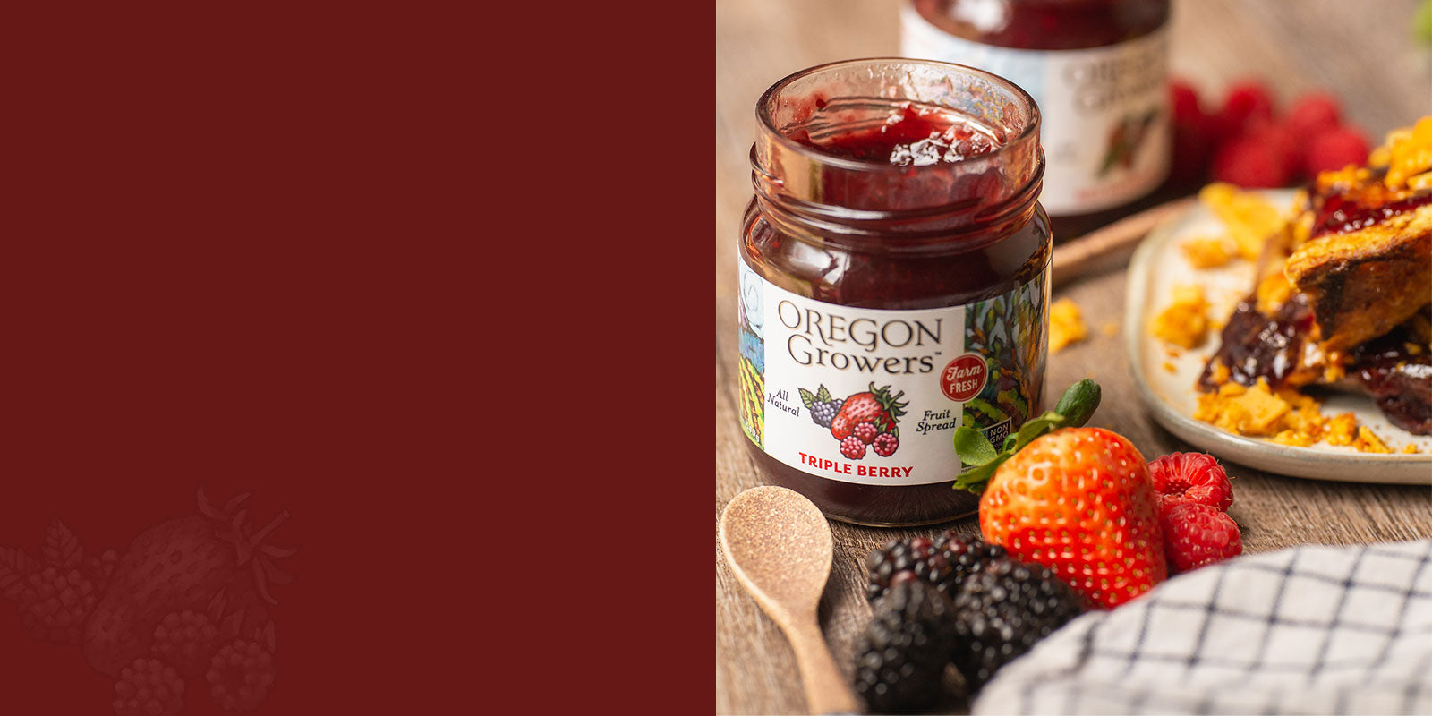 A promotional close-up of our Triple Berry jam sitting on a breakfast table next to a plate. 