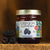 A close-up view of our Marionberry jam sitting next to some fresh marionberries.