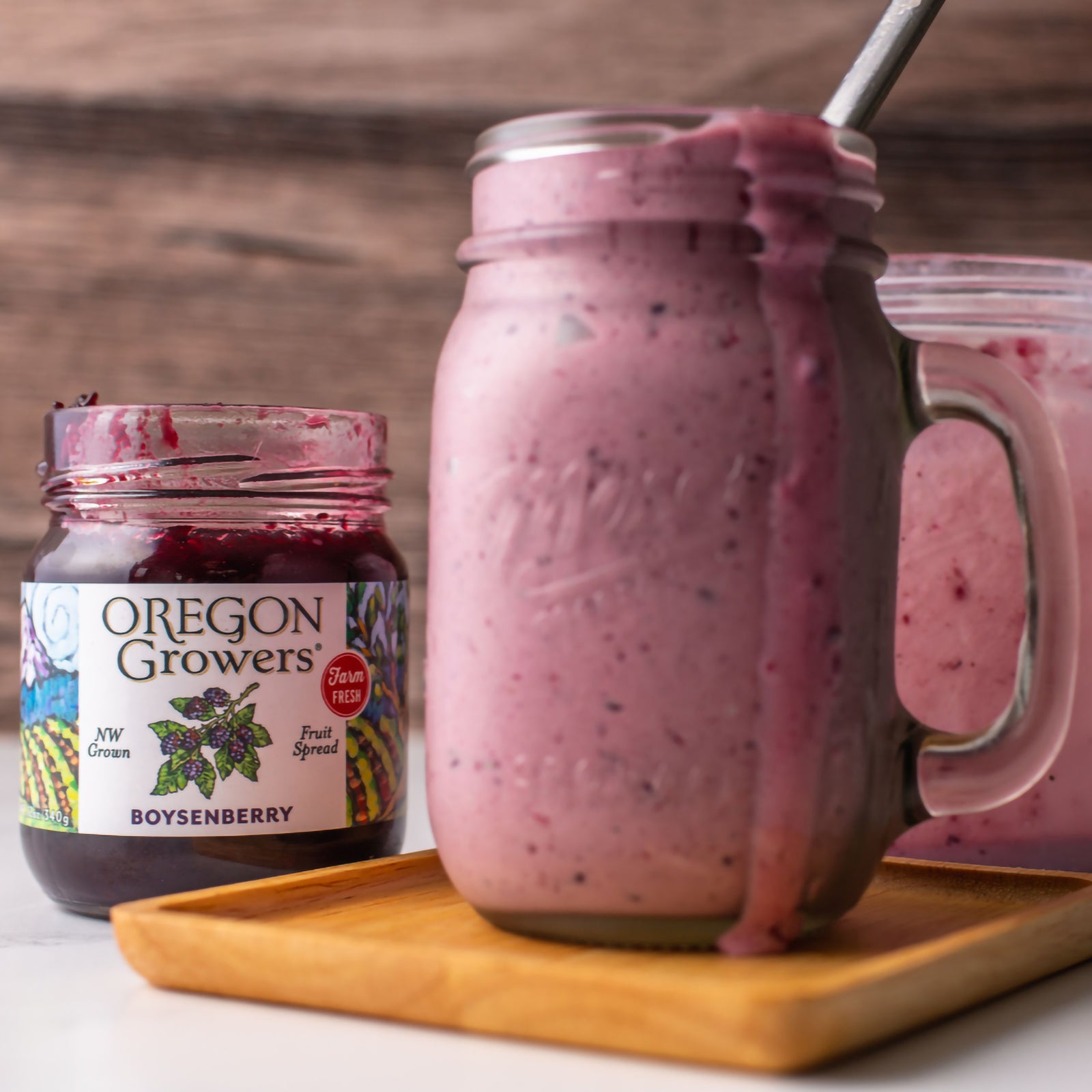 Close-up of a Boysenberry Milkshake next to the opened Oregon Growers Boysenberry Jam jar.