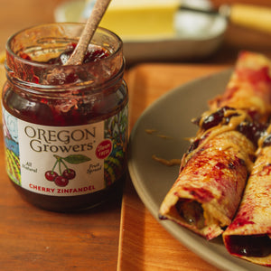 Breakfast Crepes on a plate in the morning, next to our Cherry Zinfandel Jam jar.