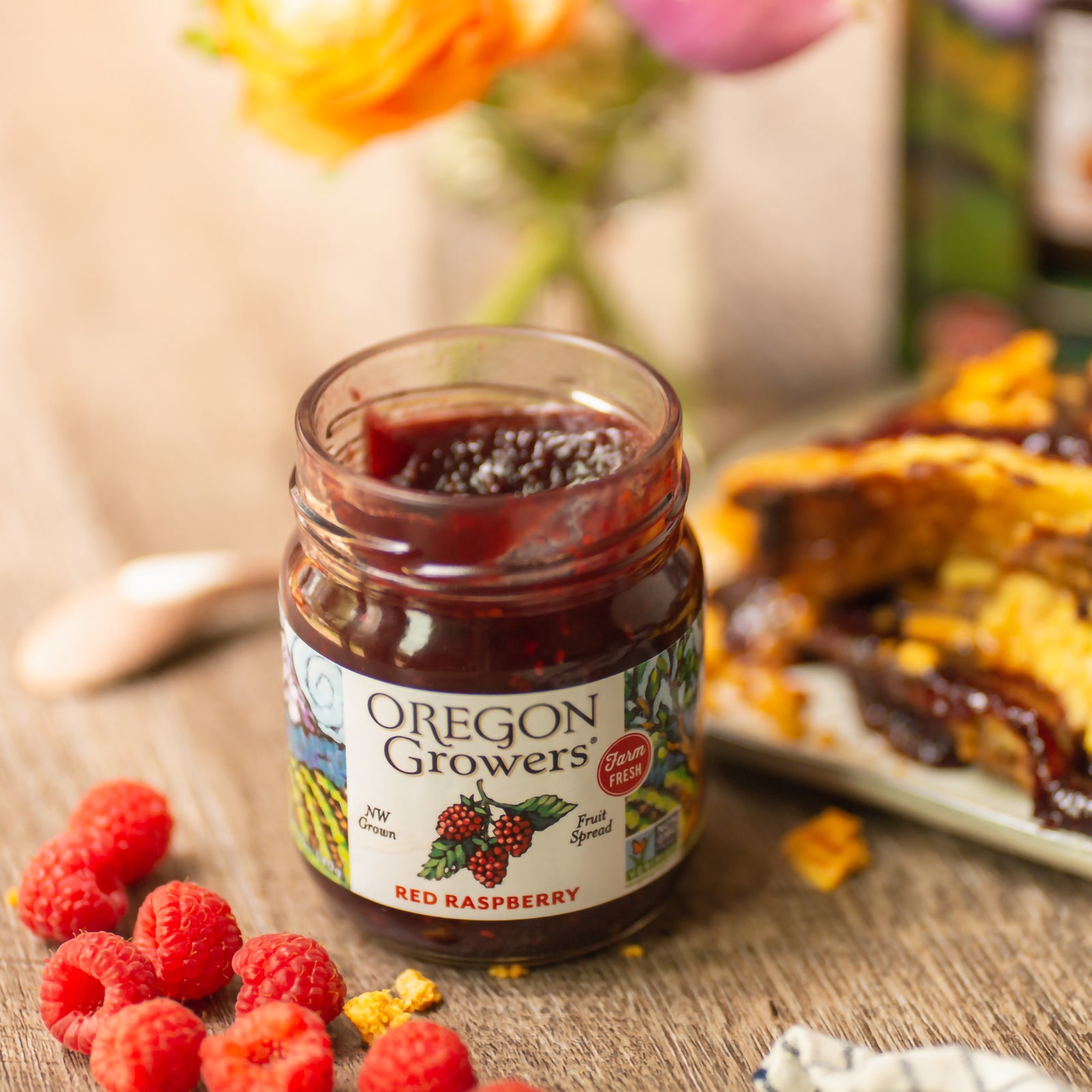 Close-up of our 12 oz Red Raspberry jar on a breakfast table.